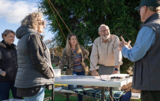 Participants learning about trout flies in a fly fishing workshop