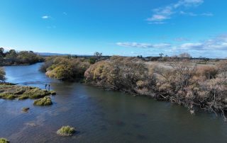 aerial view of South Esk River with 2 anglers on the bank