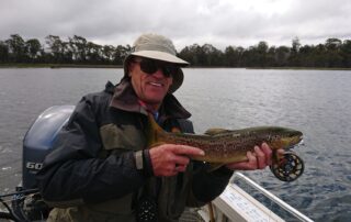 Angler holding a wild brown trout from Penstock Lagoon in Tasmania