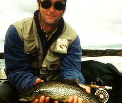 Angler holding a wild caught trout on a fly