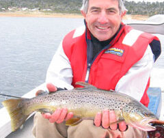 Peter holding a wild brown trout caught at Great Lake Tasmania